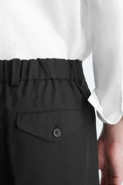 PLEATED RELAXED-FIT TAPERED PANTS